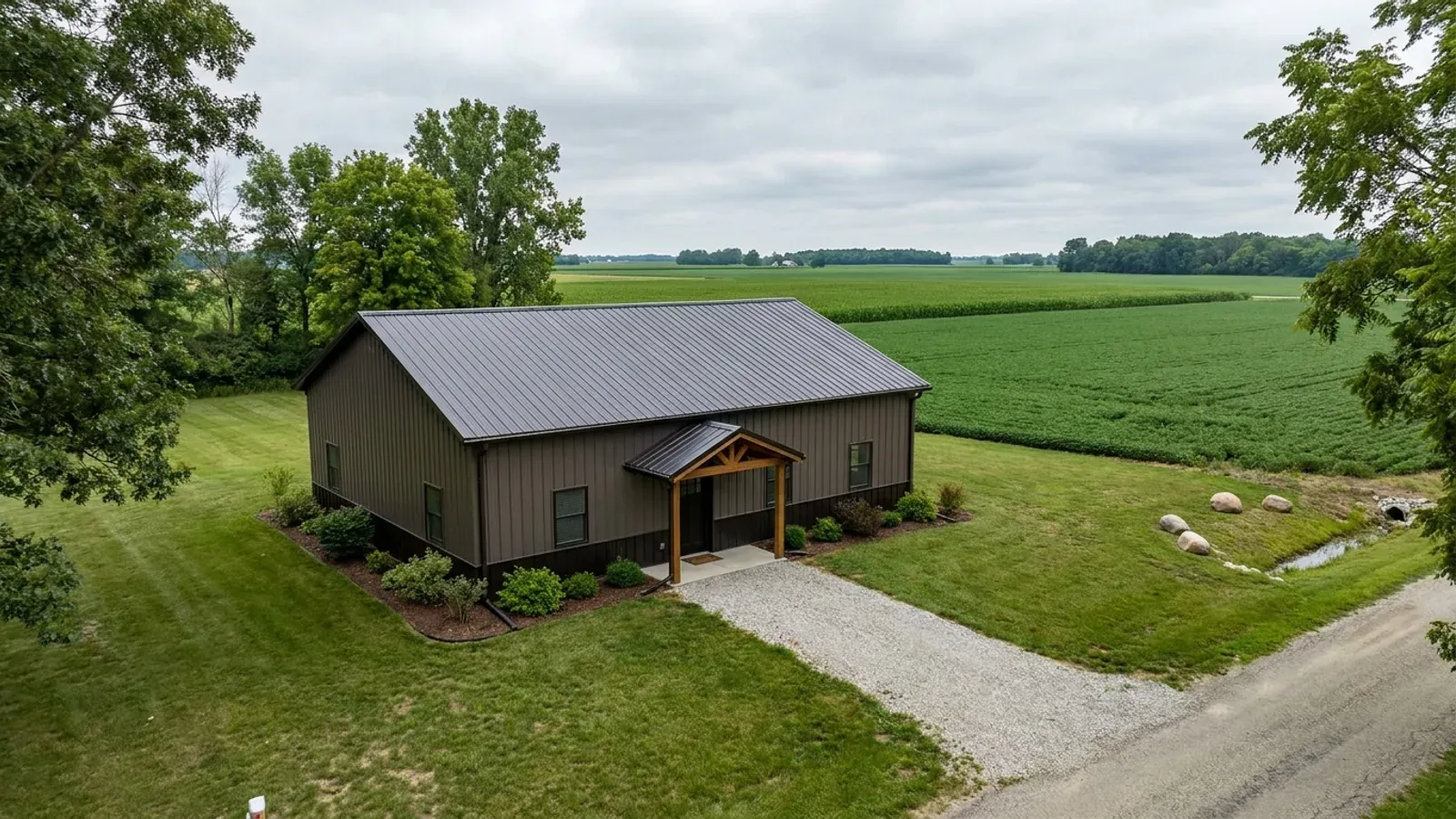 A compact 30x40 barndominium sized like a starter home or cabin, with a covered entry porch and no large shop bay.